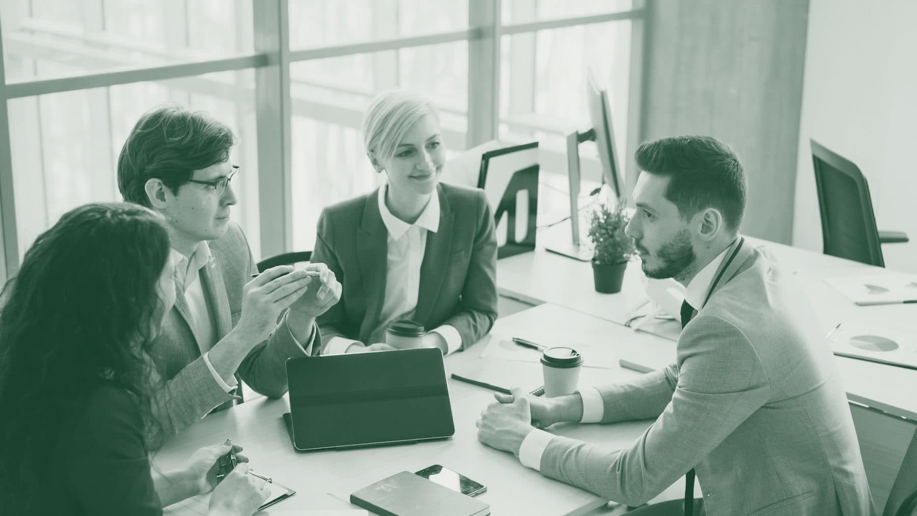 Financial professionals reviewing a case together at a conference table